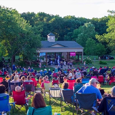 Hundreds of people gather to watch a performance at the Bandstand