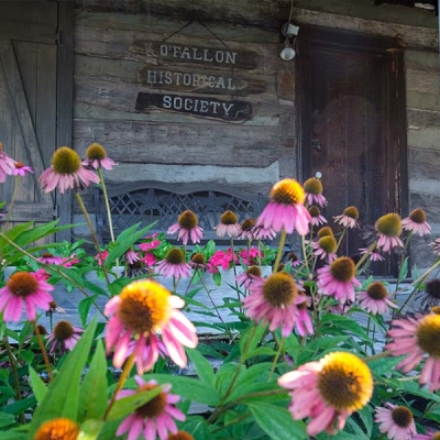 Flowers adorn the front porch of the Museum in Civic Park.